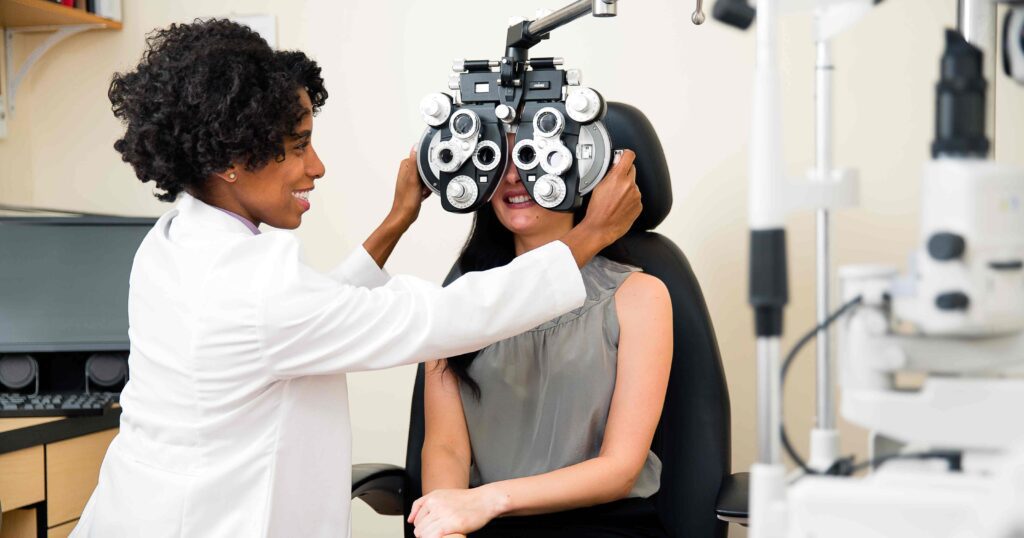 Woman getting her eyes examined by her optometrist for national eye exam month