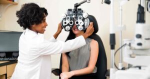 Woman getting her eyes examined by her optometrist for national eye exam month