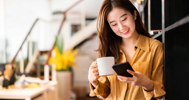 Eyeleve September Blog 2 Female looking at cell phone smiling