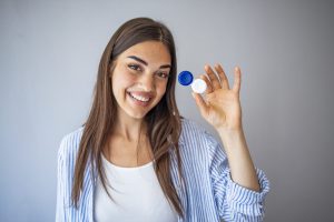 Young female holding contact lens case